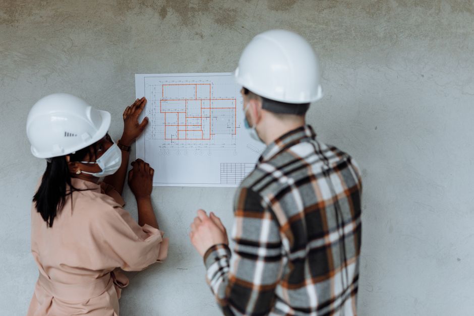 Architects reviewing building blueprints